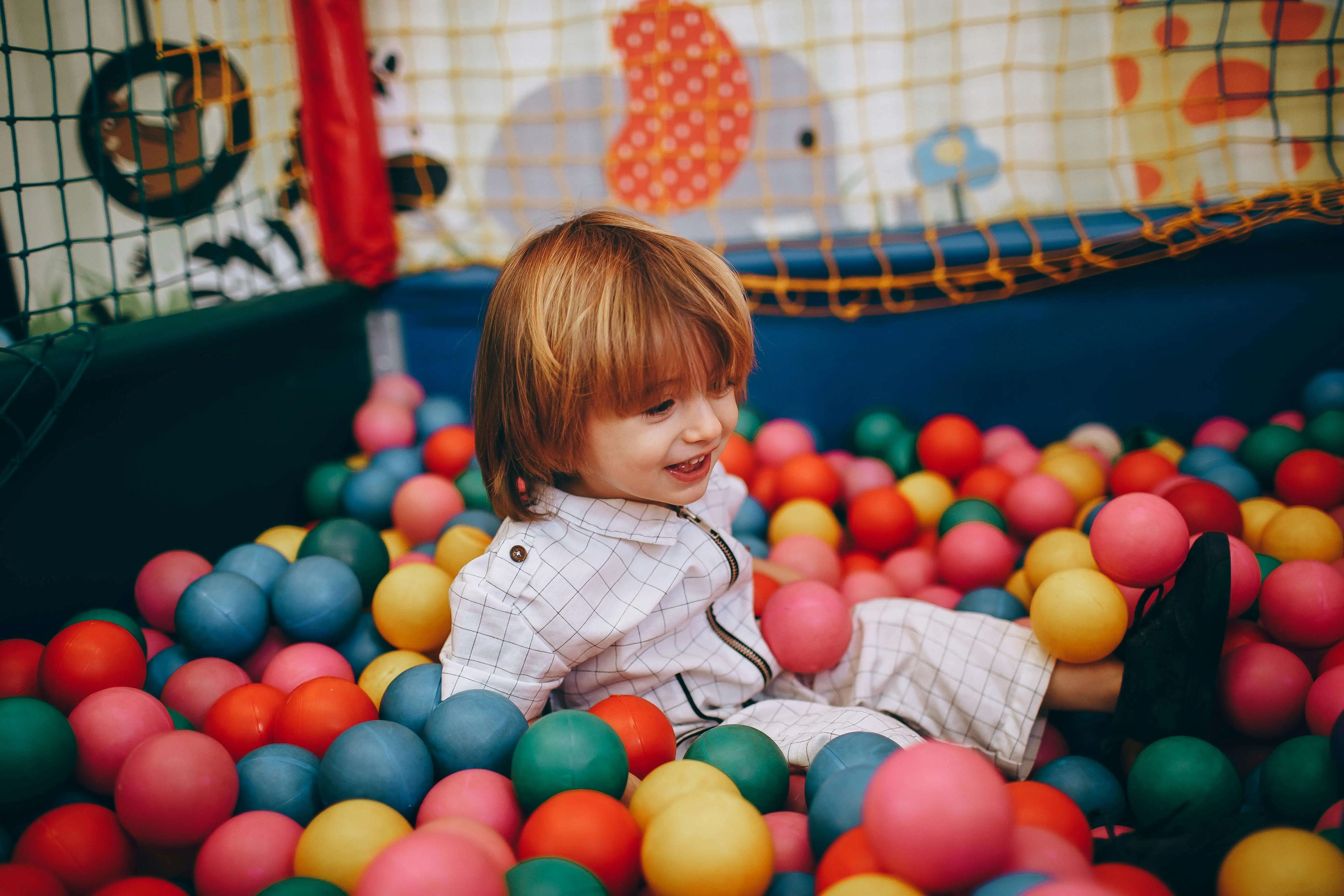 child-playing-ball-pit